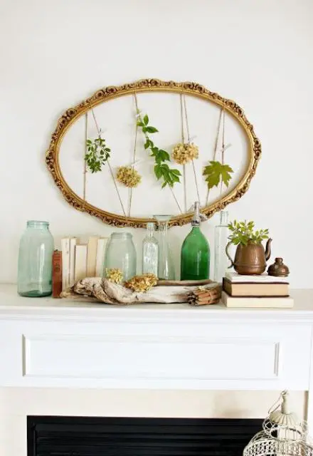 25 an artwork of a vintage oval frame with fresh leaves and blooms and greenery in a pot plus green bottles 25 an artwork of a vintage oval frame with fresh leaves and blooms and greenery in a pot plus green bottles