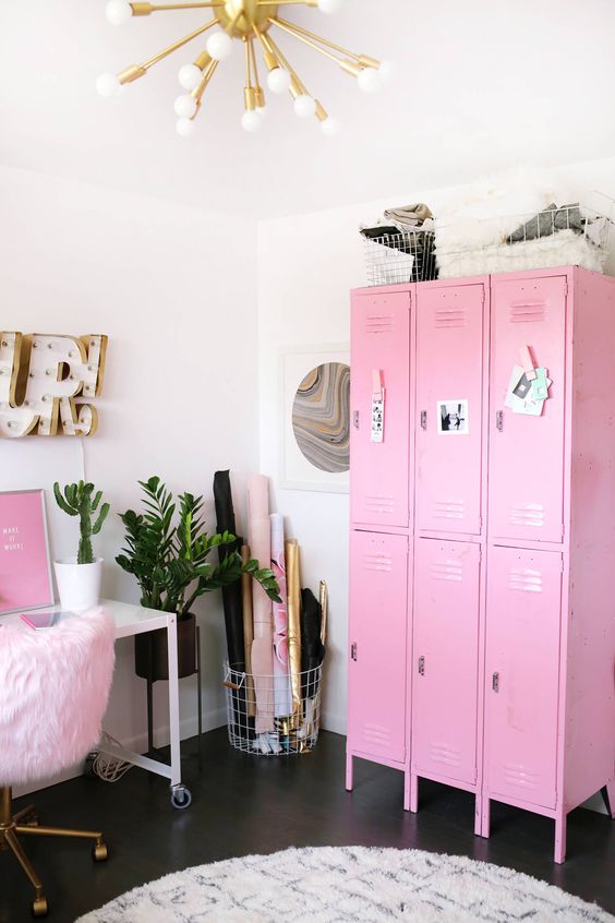 a catchy home office with a pink storage unit a pink artwork and a fluffy chair plus gold touches looks super glam